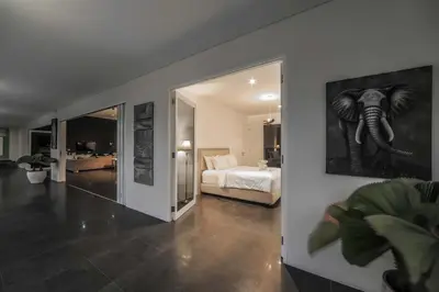 a bedroom with an elephant picture on the wall at Casa Priya Petitenget in Seminyak