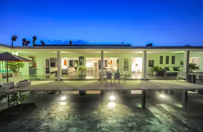 a villa with a swimming pool at night at Casa Priya Petitenget in Seminyak