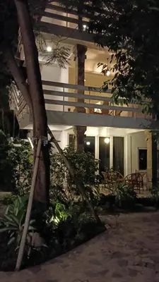 a building with a tree in front of it at Sari Bunga Hotel Legian Kuta Bali in Legian
