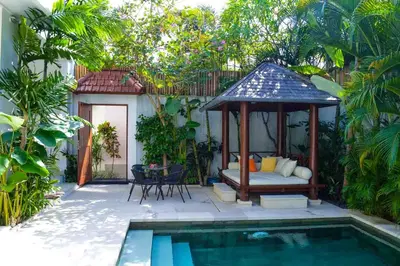 a garden with a gazebo next to a pool at Seminyak Villa Lumina in Seminyak