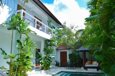 a villa with a swimming pool and a house at Seminyak Villa Lumina in Seminyak
