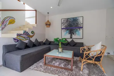 a living room with a couch and a table at Villa K-Mea in Seminyak