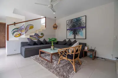 a living room with a couch and a table at Villa K-Mea in Seminyak