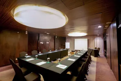 a large conference room with a long table and chairs at THE 1O1 Bali Fontana Seminyak in Legian