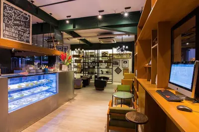 a restaurant with a counter and a bakery with a counter at THE 1O1 Bali Fontana Seminyak in Legian