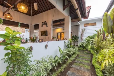 a courtyard in a house with plants at Villa Kamboja Five in Seminyak