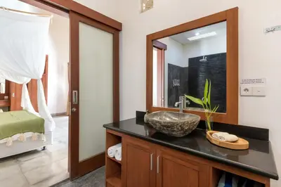 a bathroom with a sink and a mirror at Villa Cinta Umalas in Canggu