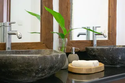 two sinks in a bathroom with two mirrors at Villa Cinta Umalas in Canggu