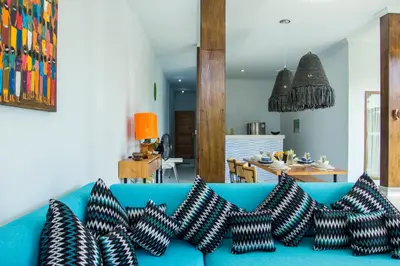 a blue couch with four black and white pillows at Villa Orked 2 in Seminyak