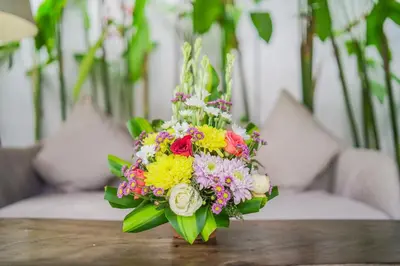 a bouquet of flowers sitting on top of a table at The Lagoon Canggu in Canggu