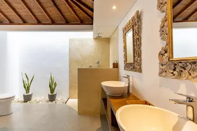 a bathroom with a sink and a mirror at The Lagoon Canggu in Canggu