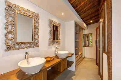 a bathroom with two sinks and a mirror at The Lagoon Canggu in Canggu