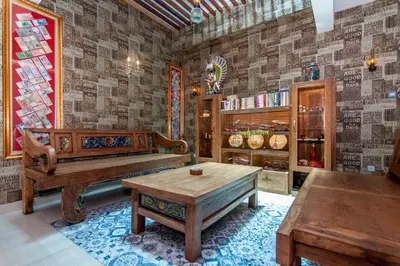 a living room with wooden furniture and a table at Rhadana Hotel in Kuta