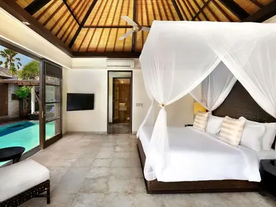 a bedroom with a bed and a pool at Peppers Seminyak in Seminyak