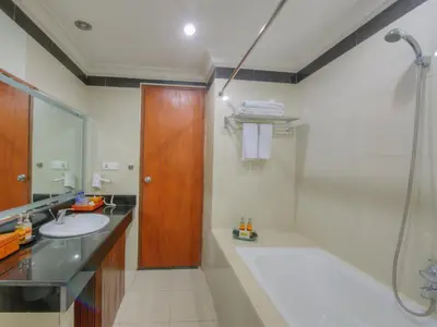 a bathroom with a sink and a shower at Hotel Vila Lumbung in Seminyak