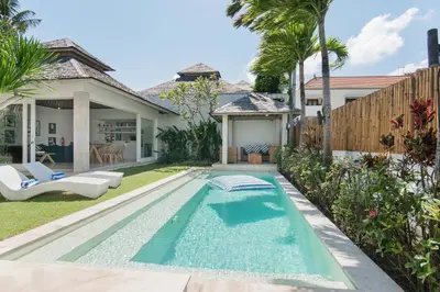 a swimming pool in the backyard of a house at The Plantation at Batu Belig in Canggu