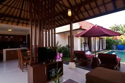 a living room with a television and a pool at The Awan Villas Seminyak in Seminyak