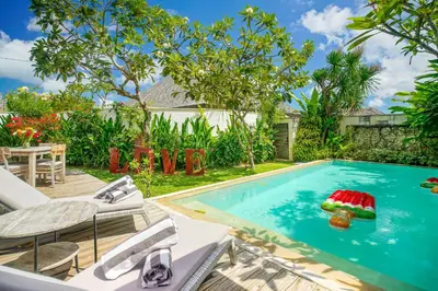 a swimming pool with a pool noodle in the middle at Villa Love Umalas in Kerobokan