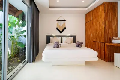a bedroom with a bed with teddy bears on it at Villa Love Umalas in Kerobokan