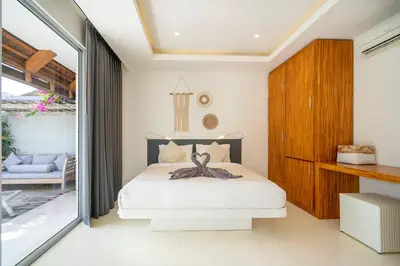 a bedroom with a bed and a sliding glass door at Villa Love Umalas in Kerobokan