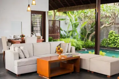 a living room with a white couch and a coffee table at The Astari Villa and Residence in Jimbaran