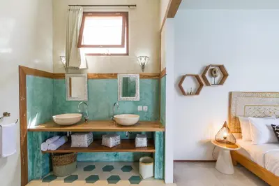 a bathroom with two sinks and a bed at Villa Maje by Alfred in Bali in Seminyak