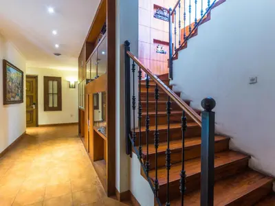 a hallway with a staircase in a house at Alron Hotel Kuta in Kuta