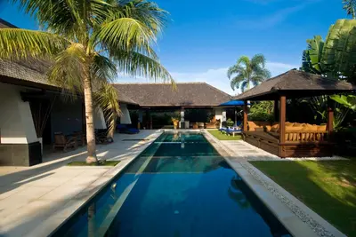 a swimming pool in front of a house at Anyar Estate in Canggu