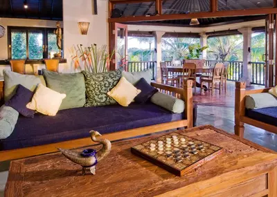 a living room with a couch and a chessboard on a table at Anyar Estate in Canggu