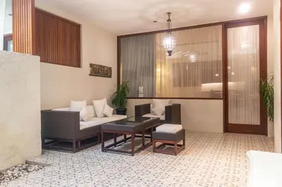 a living room with a couch and a table at Arana Suite in Legian