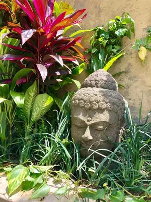 a stone statue in the middle of some plants at 3BR Villa Carissa Seminyak Centre, Bali by Le Ciel Hospitality in Seminyak