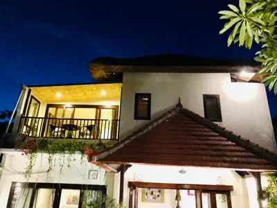 a building with a balcony with a table on it at 3BR Villa Carissa Seminyak Centre, Bali by Le Ciel Hospitality in Seminyak