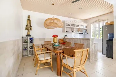 a dining room with a wooden table and chairs at 3BR Villa Carissa Seminyak Centre, Bali by Le Ciel Hospitality in Seminyak