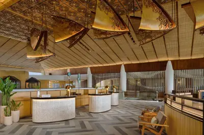 a rendering of a hotel lobby with tables and chairs at Sheraton Bali Kuta Resort in Kuta