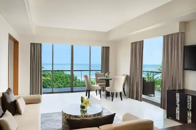 a living room with a view of the ocean at Sheraton Bali Kuta Resort in Kuta