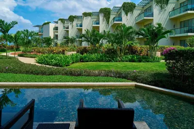 a resort with a swimming pool in front of a building at Sheraton Bali Kuta Resort in Kuta