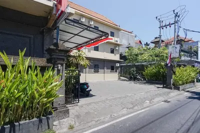 a street with a car parked next to a building at Gana Inn Legian in Legian