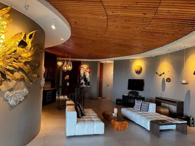 a living room with a couch and a tv at Dacolina House in Jimbaran