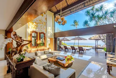 a living room with a couch and a table at AYANA Villas Bali in Jimbaran