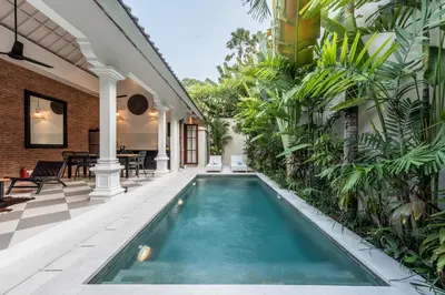 an indoor pool in a house with plants at Central 3 Bedroom Villa close to Seminyak Beach in Seminyak