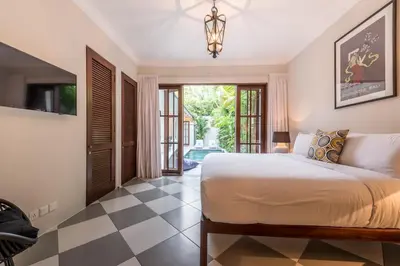 a bedroom with a bed and a checkered floor at Central 3 Bedroom Villa close to Seminyak Beach in Seminyak