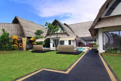 a house with two chairs and a yard at Villa Seminyak Estate & Spa - By Astadala in Seminyak