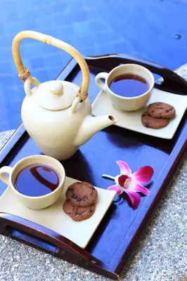 a tray with two cups of coffee and cookies at Villa Seminyak Estate & Spa - By Astadala in Seminyak