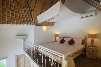 a bedroom with a bed on a balcony at Villa Seminyak Estate & Spa - By Astadala in Seminyak