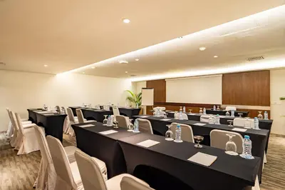 a conference room with long tables and chairs at Bintang Kuta Hotel in Kuta