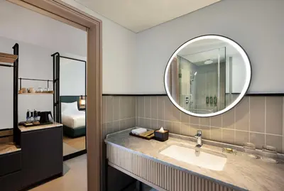 a bathroom with a sink and a mirror at Hilton Garden Inn Bali Nusa Dua in Nusa Dua