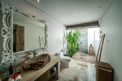a bathroom with a mirror and a sink and a toilet at Villa Koala, 2Br Close to W, Potato Head and Shi Shi in Seminyak
