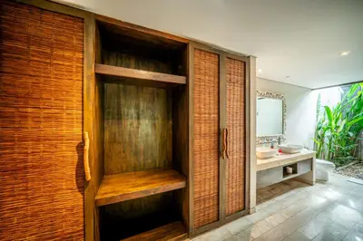 a bathroom with a wooden door with a sink at Villa Koala, 2Br Close to W, Potato Head and Shi Shi in Seminyak