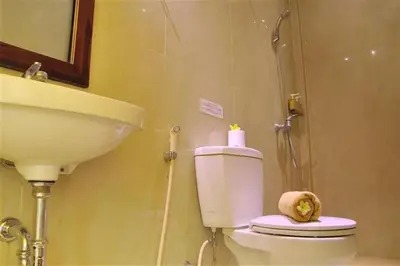 a bathroom with a sink and a toilet and a shower at Sari Stay in Jimbaran