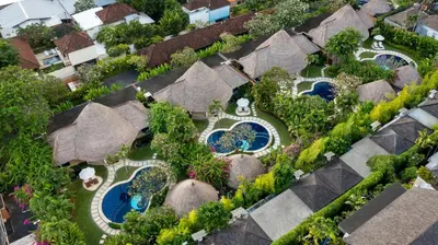 an overhead view of a resort with swimming pools at Impiana Private Villas Seminyak in Seminyak